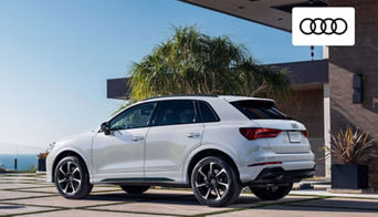 Coupe-style Audi SUV lineup displayed outside the Audi Dayton dealership on Springboro Pike.