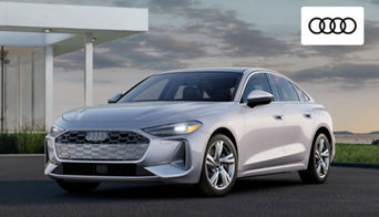 Audi A5 Sportback driving through suburban Dayton, OH, showcasing its sleek profile 