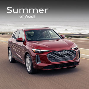 Passenger side view of an Audi Q5 SUV driving.