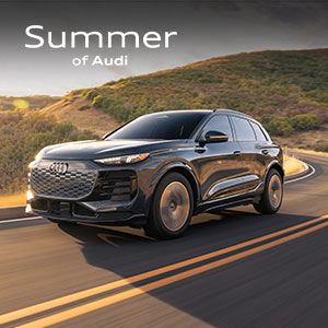 Driver side view of an Audi Q6 e-tron driving.