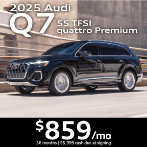 Side view of an Audi Q7 driving.