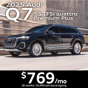 Side view of an Audi Q7 driving.