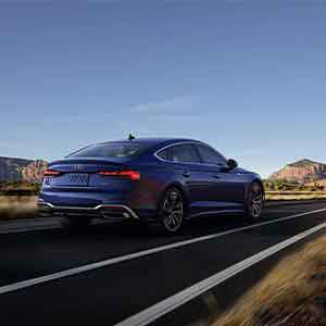 Back view of an Audi A5 driving.