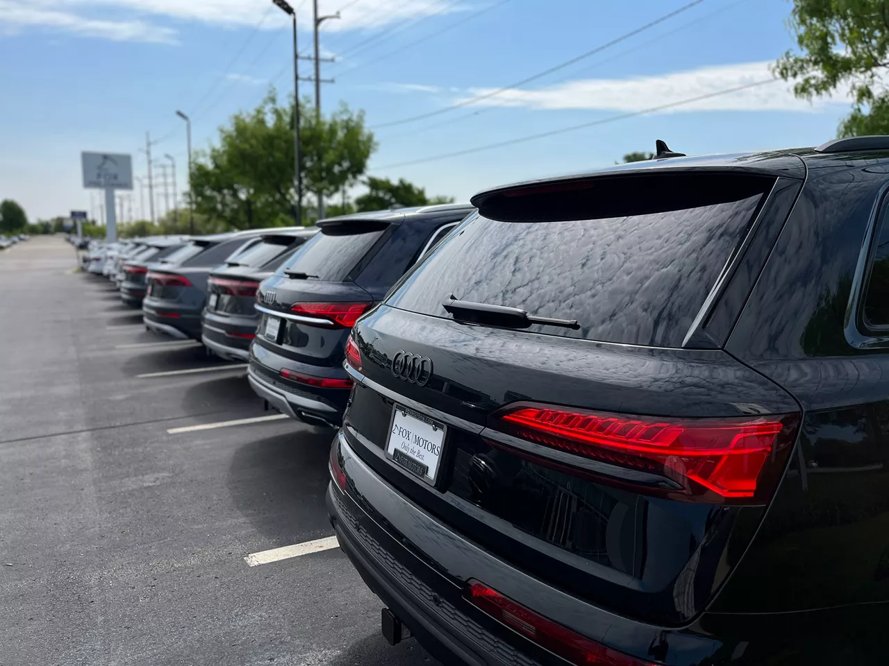 Audi vehicles in parking lot. 