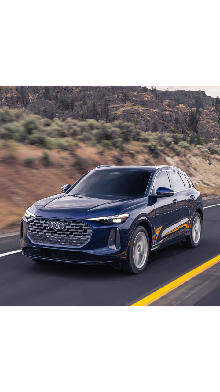 Left side profile view of an Audi Q6 parked.