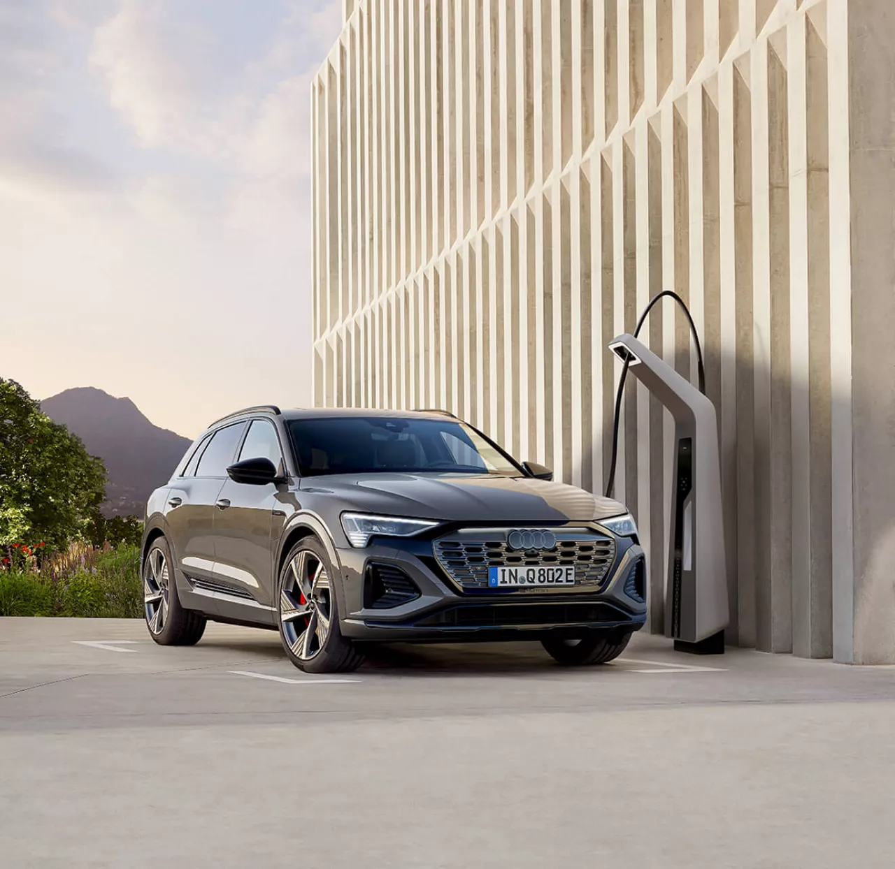 Audi SUV charging at a charging station