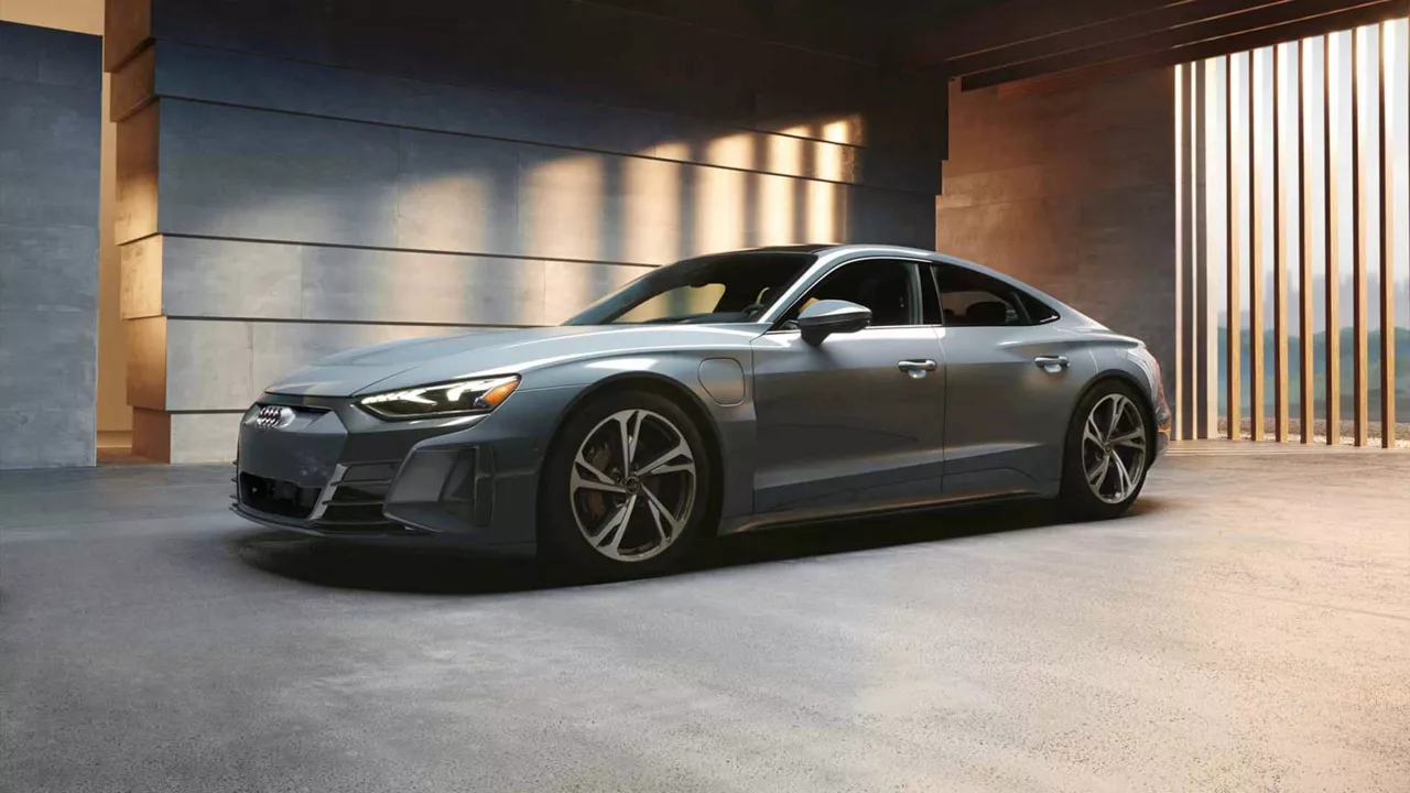 Three-quarter front view of an Audi vehicle parked inside a modern building.