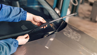 Technician installing a wiper blade