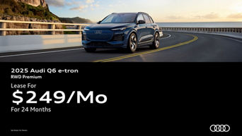 Three quarter view of an Audi Q6 e-tron driving.