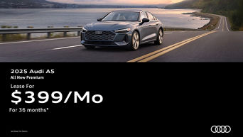 Three quarter view of an Audi A5 driving.