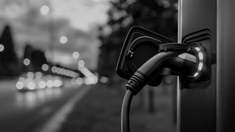 Black and white image of an EV charging connector