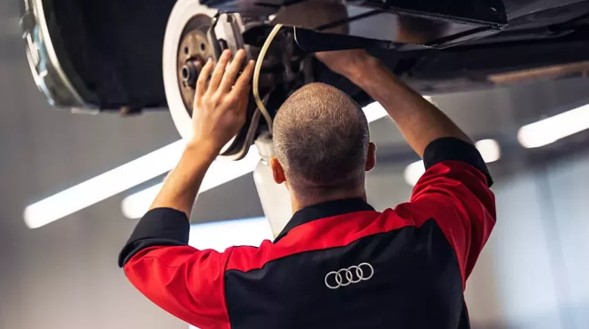 Service Mechanic Working on Brakes