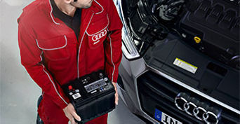 Service technician replacing battery.