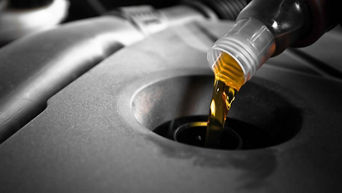 Service fluid being poured into car.