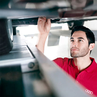 Service technician serving vehicle.