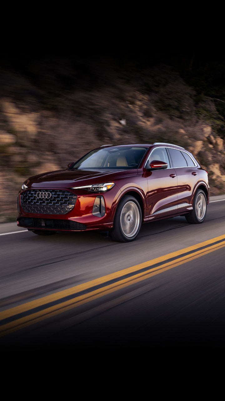 Three quarter profile view of an Audi Q5 accelerating.