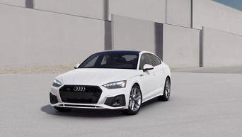 Three quarter profile view of an Audi A5 parked.