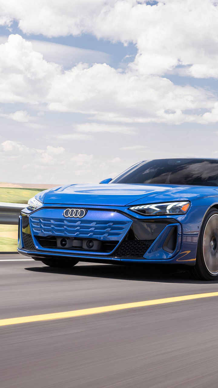 Audi 2025 Audi S e-tron GT left profile driving.