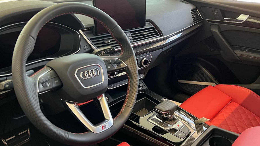 Audi Sale Specialist walking through the showroom with a couple.