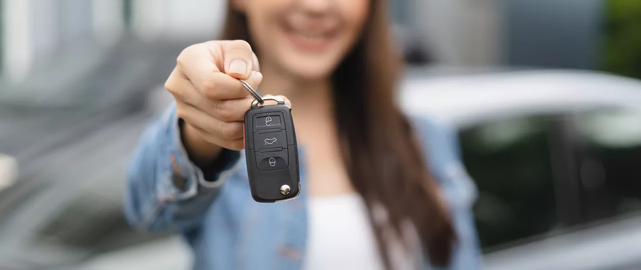 Woman showing off the keys to her used Audi