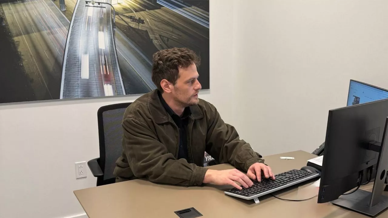 Audi State College employee using a computer in their office