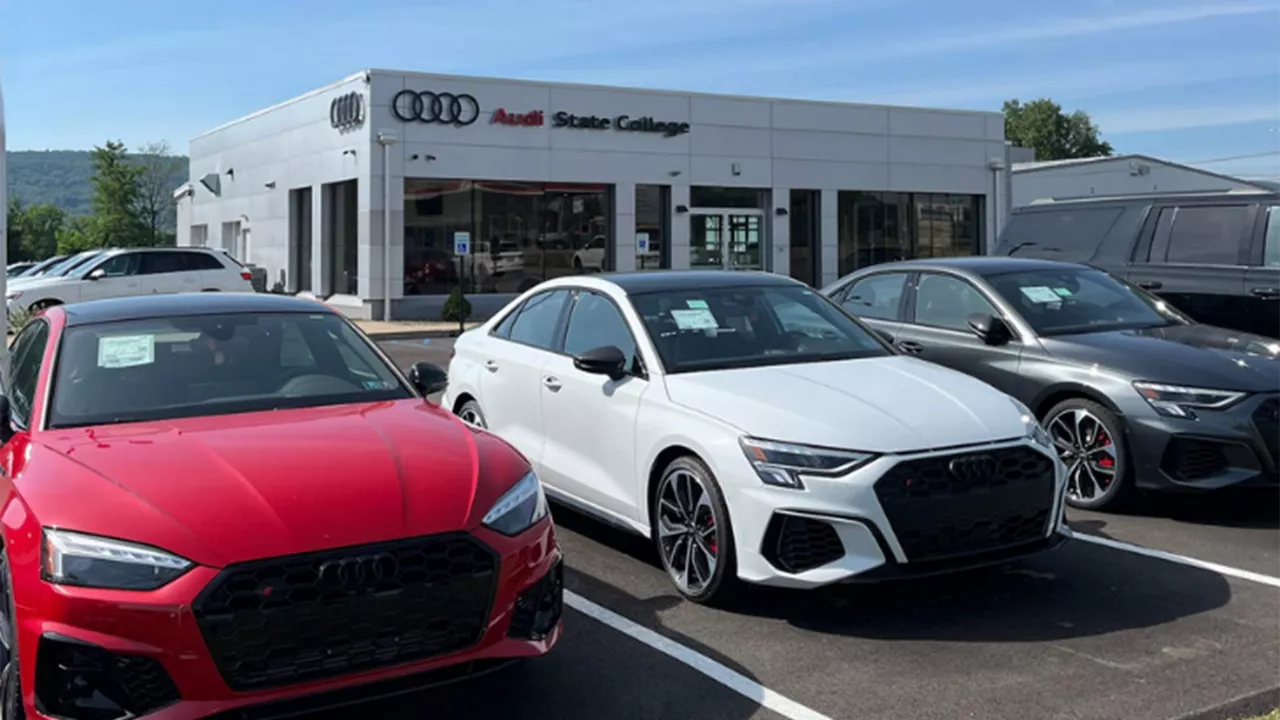 Audi vehicles parked in front of the Audi State College dealership