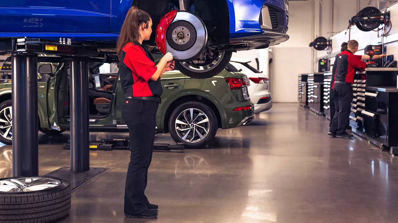 Audi Service Advisor working on tire