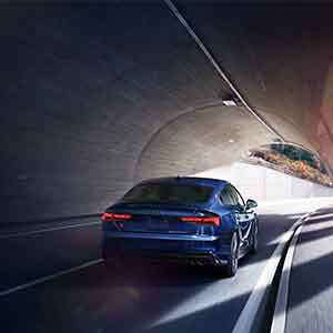 Back view of an Audi S5 driving.