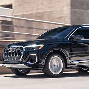 Side view of an Audi Q7 driving.