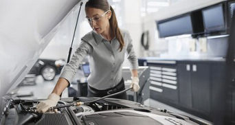 Service technician serving vehicle.