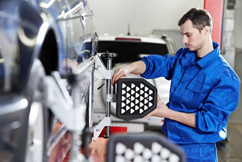 Service technician serving vehicle.