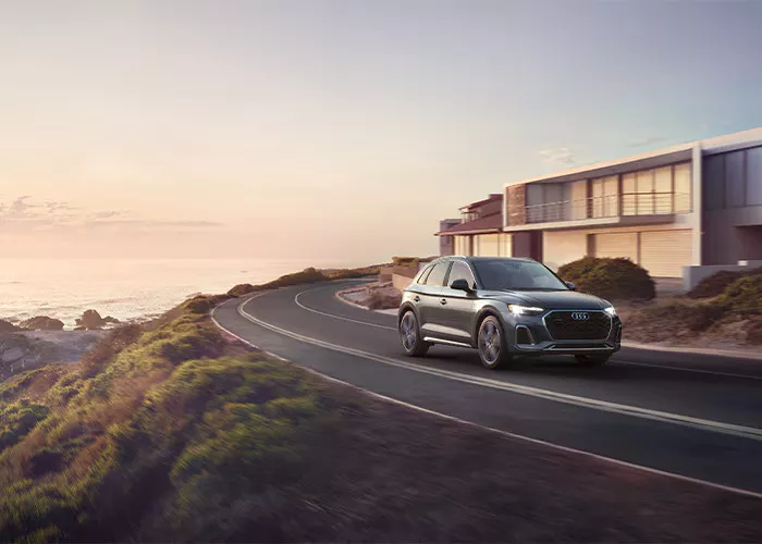 New Audi Q5 drive through a banked road.