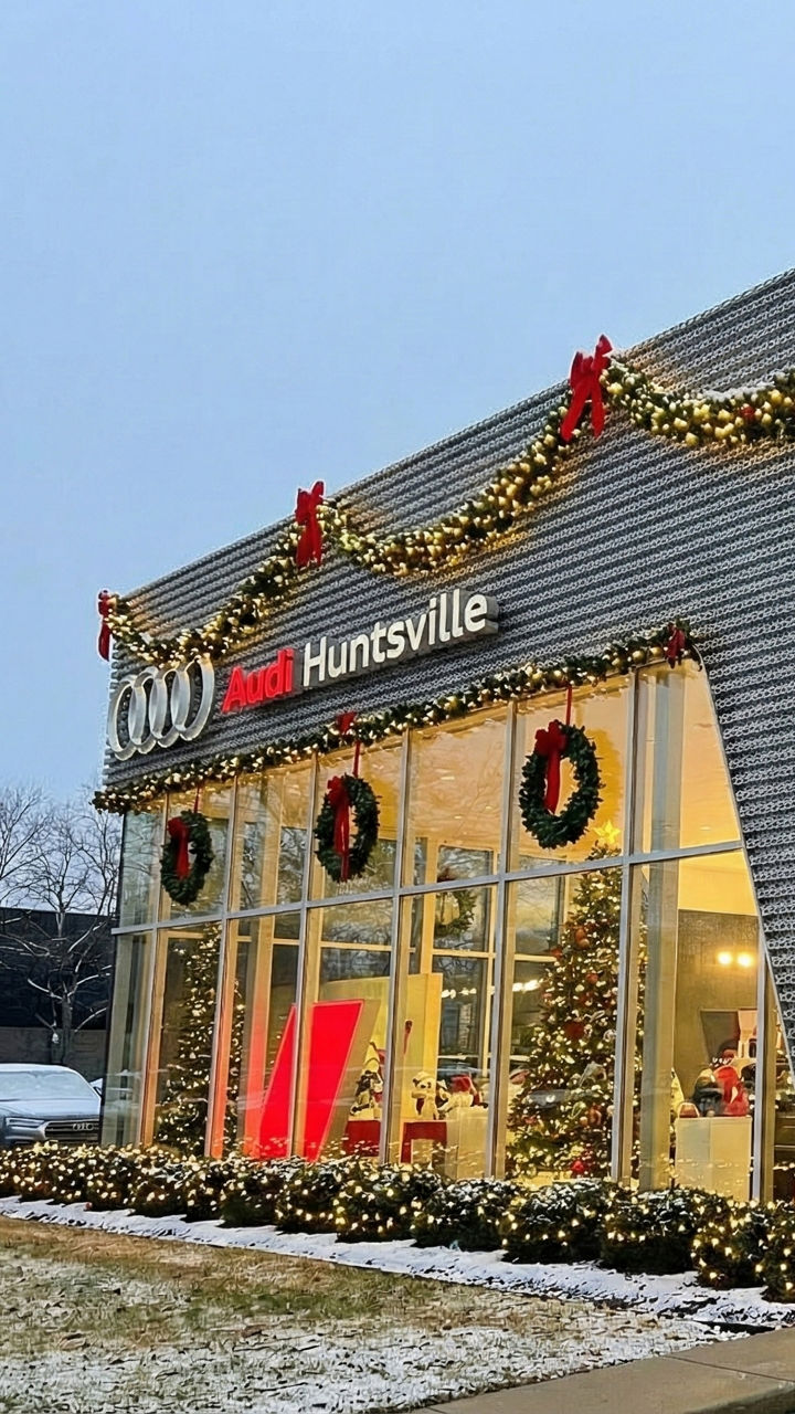Front profile view of the Audi Huntsville dealership in the sunset.