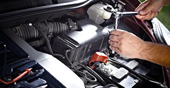 Service technician serving vehicle.