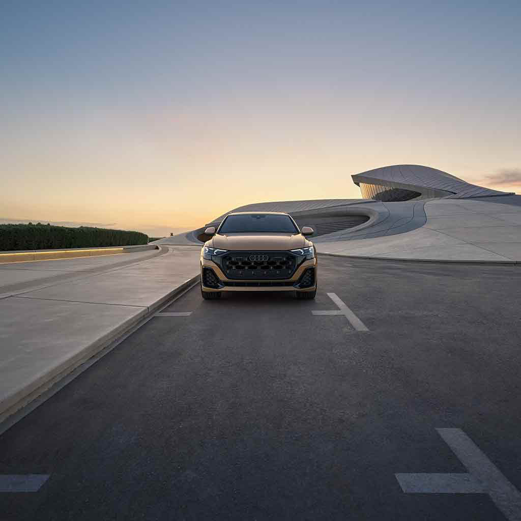 Front profile view of an Audi Q8 parked.