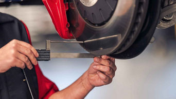 Service technician inspecting breaks.