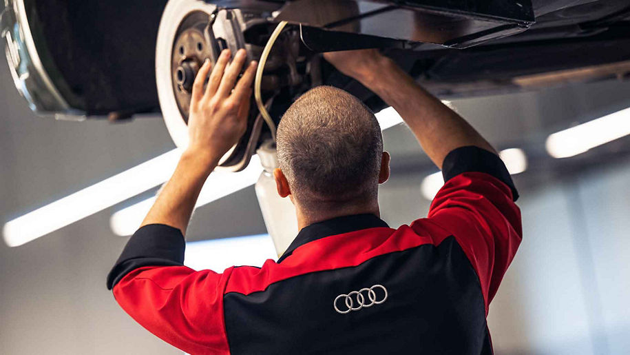 Service technician servicing a vehicle