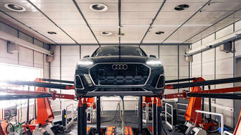 Audi on a lift for service that was picked up and delivered. 