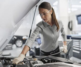Service technician servicing vehicle.