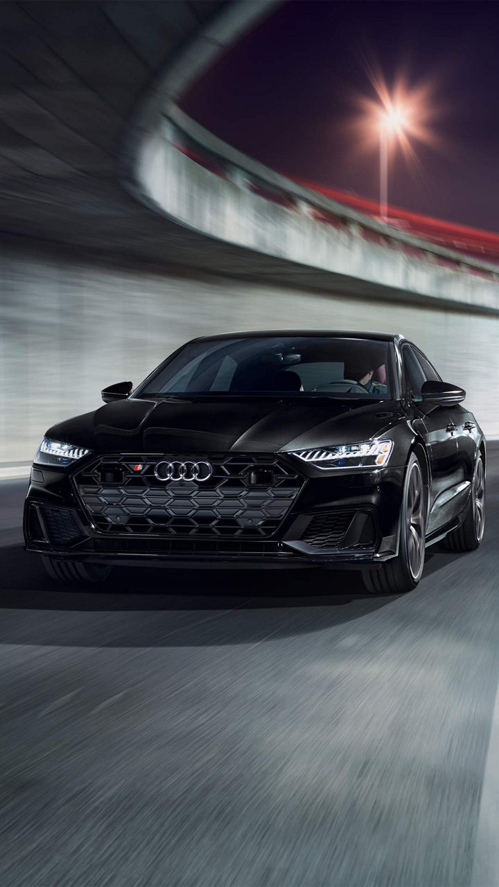 Front view of a black Audi sedan accelerating