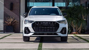 Three quarter profile view of an Audi Q3 SUV parked.