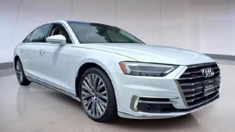 Three quarter profile view of an Audi A8 L 55 TFSI® quattro® tiptronic®