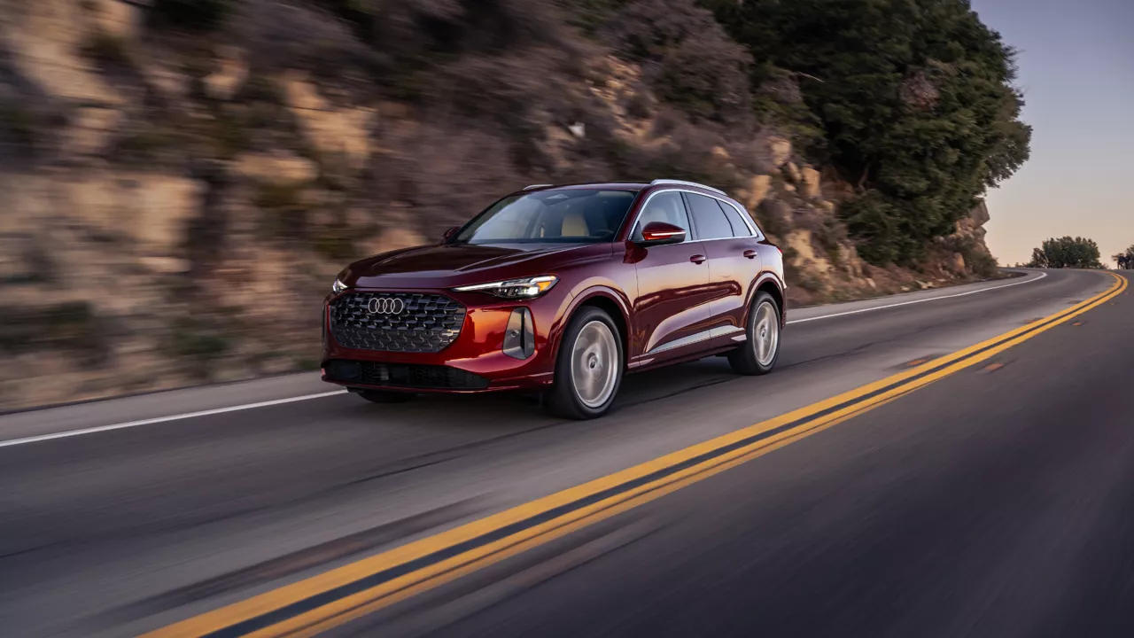 Left profile view of an Audi q5 vehicle accelerating.