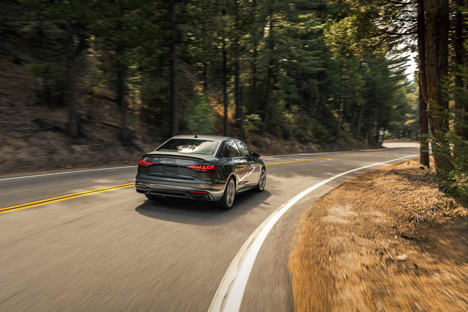 Rear profile view of an Audi A4 accelerating.