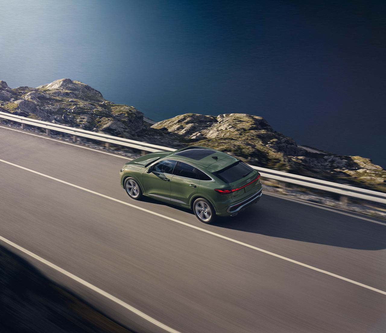 Right profile view of an Audi A5 accelerating.