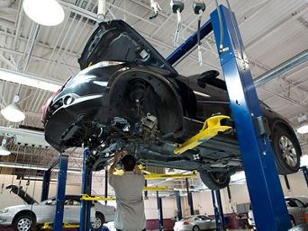 Service technician serving vehicle.