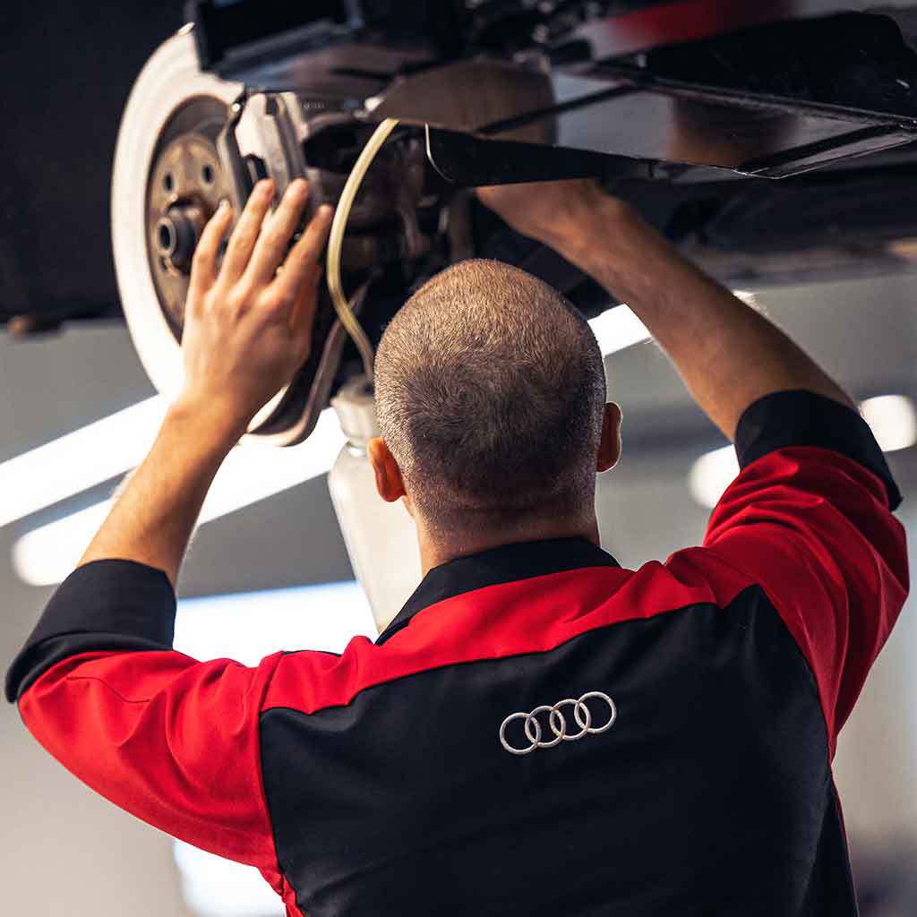 Service technician servicing a vehicle
