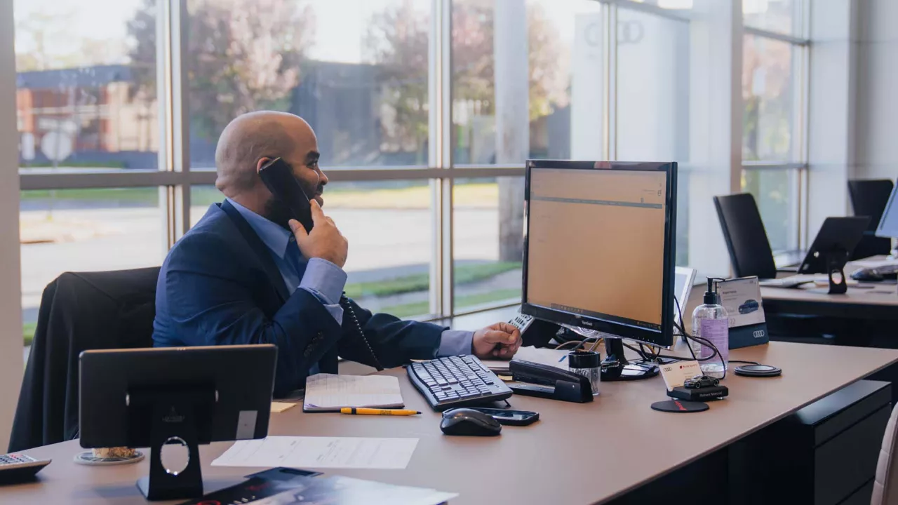 Audi Englewood salesperson taking a call