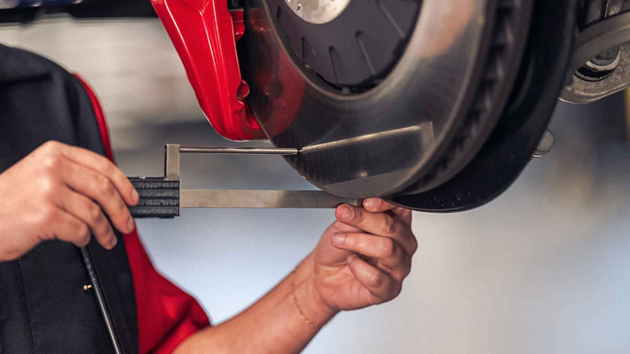 Audi service technician servicing a vehicle.