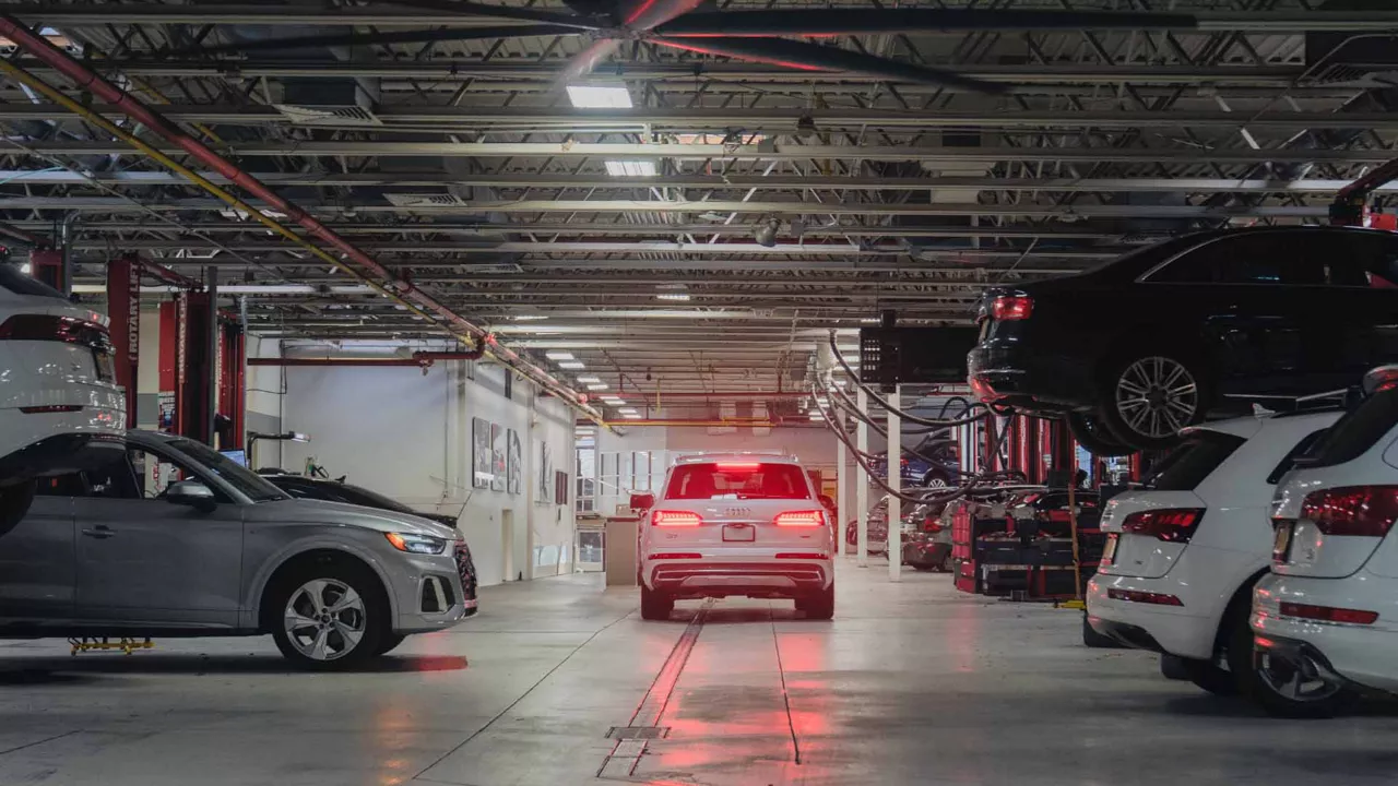 Rear view of an audi vehicle driving through a garage.